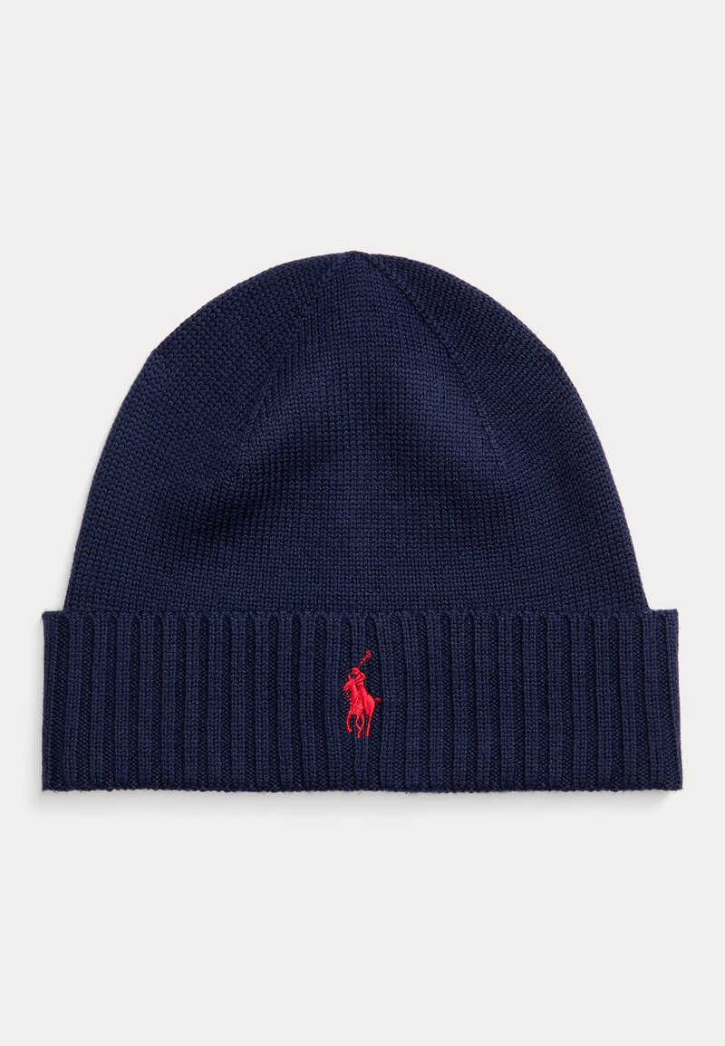 Knit navy beanie with a ribbed cuff, featuring a small red polo logo on the side. Soft texture and fitted design.