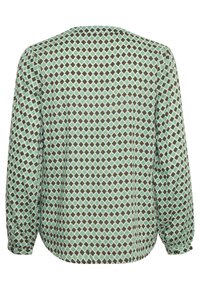 Blouse femme à manches longues avec motif géométrique de losanges verts et marrons, poignets boutonnés et ourlet arrondi, vue de dos.