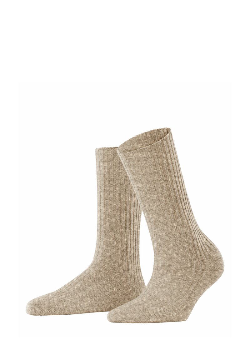 Beige ribbed socks made from a soft material; mid-calf length with a textured design and a smooth toe area. Standard pair.
