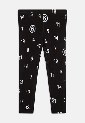 Leggings negras con un estampado blanco de números en toda la prenda, que incluye círculos de varios tamaños. Material suave con un diseño ajustado.