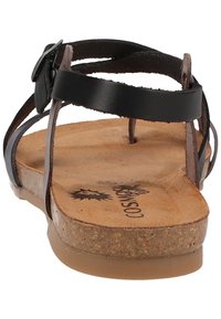 Sandal in pelle nera con fasce sottili e suola in sughero. Sole piatto, fibbia regolabile, finitura naturale e interno testurizzato.