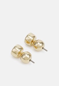 Boucles d'oreilles en ton or présentant un design lisse et arrondi avec une combinaison de formes cylindriques et sphériques. Caractérisées par une finition polie.