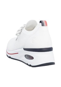 White sneaker with a textured mesh upper, featuring a lace closure and a contrasting red and navy-striped heel tab. Air cushion detail on sole.