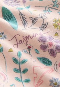 Light pink fabric with a floral pattern featuring purple flowers, green leaves, and a teapot illustration. Includes the name "Jasmine" in cursive.