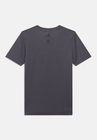 Sivý krátky rukáv s okrúhlym výstrihom, vyrobený z mäkkej tkaniny. Obsahuje malé čierne logo Adidas na hornej časti chrbtovej časti. Jednoduchý dizajn.