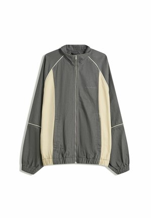 Gray and cream zip-up jacket with a stand collar, elastic cuffs, and waistband. Features logo on the chest and contrasting side panels.