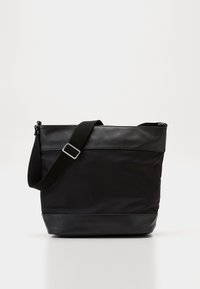 Borsa a tracolla nera con una parte superiore in nylon testurizzato e una base in pelle liscia, dotata di una tracolla regolabile e accenti in metallo argentato.