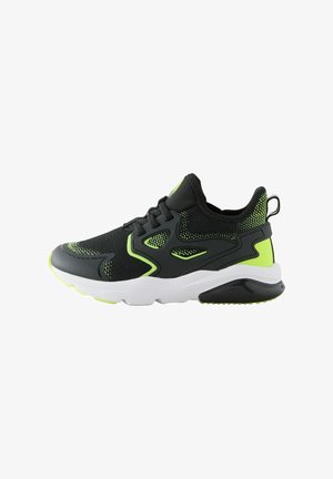 Black athletic shoe with mesh fabric, neon green accents, thick white sole, textured upper, and lacing system for secure fit.