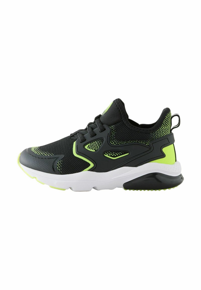 Black athletic shoe with mesh fabric, neon green accents, thick white sole, textured upper, and lacing system for secure fit.