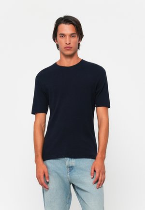 Navy blue, short-sleeve t-shirt with a round neckline. Made of soft fabric, fitted design, featured with subtle stitching details.