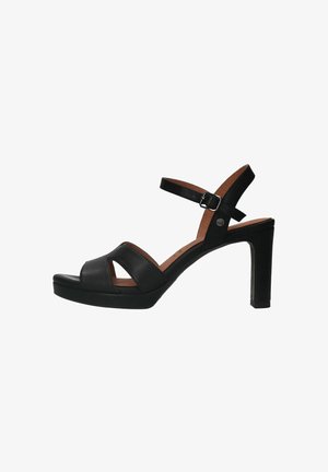 Sandales à talons en cuir noir avec plateforme, présentant des brides croisées à l'avant, une sangle de cheville avec une boucle et un talon bloc solide.