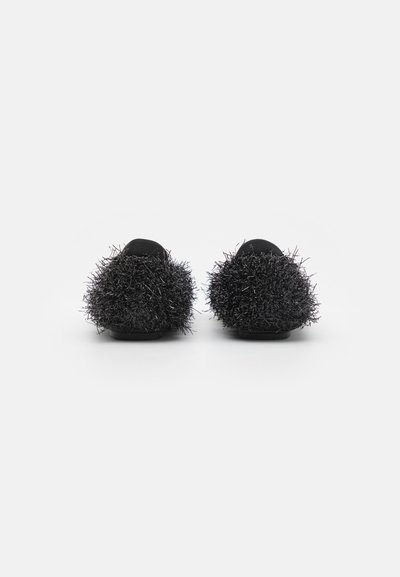 Black plush slippers featuring fuzzy, textured accents at the back, made with a soft upper and flat sole design for comfort.