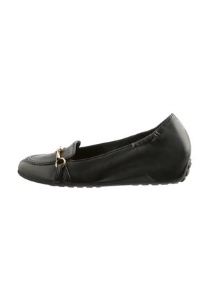 Black leather flat shoe with a rounded toe, decorative gold hardware, and a flexible rubber sole. Features a smooth texture and slip-on design.