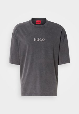 Gray casual t-shirt with short sleeves, rounded neckline, front embroidered "HUGO" logo in a lighter shade, made from soft fabric with a smooth texture.