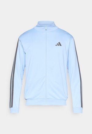 Lichtblauw jack met rits, gemaakt van soepel materiaal, met grijze gestreepte accenten op de mouwen en een klein zwart logo op de borst.