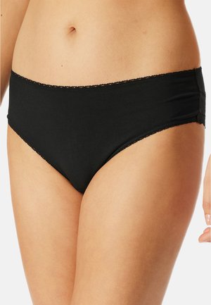 Schwarze Baumwollunterhose mit glatter Textur, niedrig geschnittenem Design und Spitzenbesatz entlang des Bunds und der Beinöffnungen.