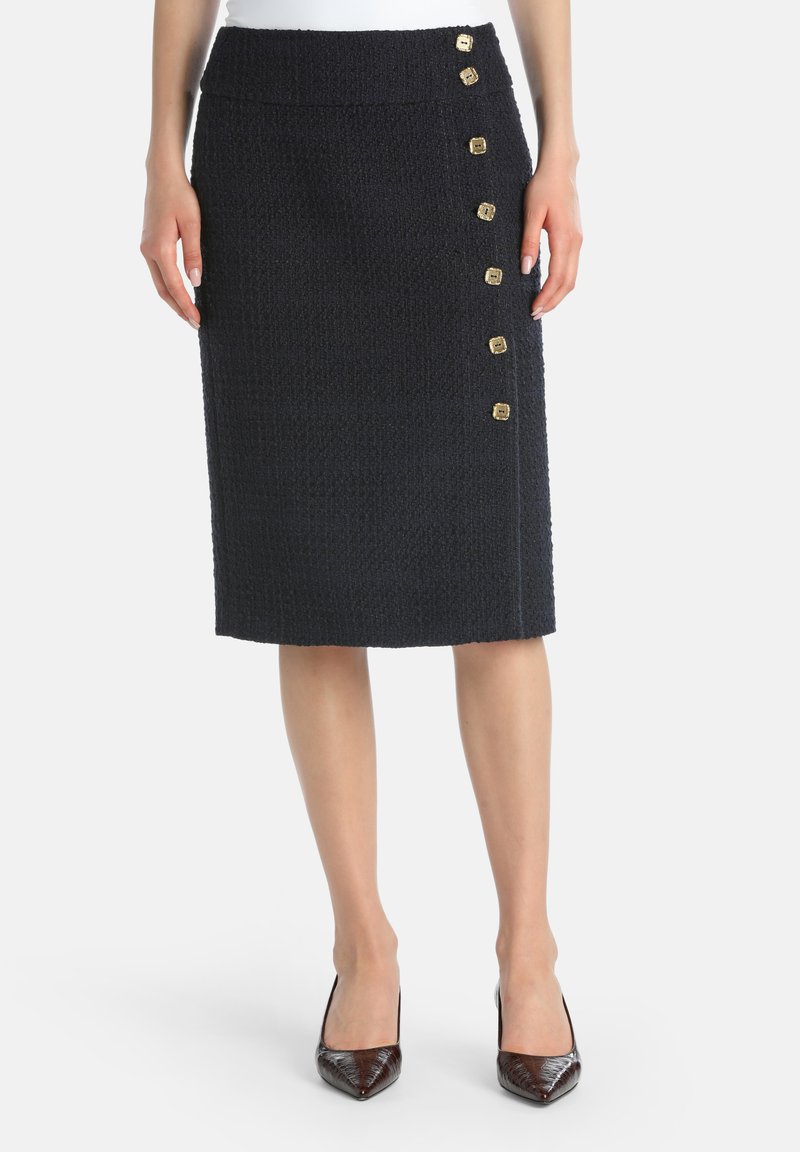 Black textured knee-length skirt with six gold square buttons down the right side, worn with dark pointed-toe heels.