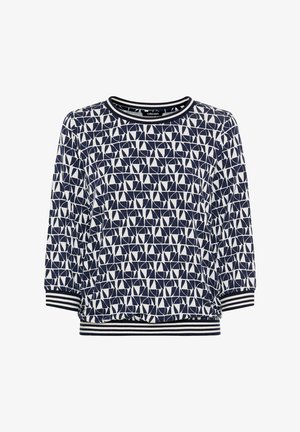 Navy and white geometric patterned long-sleeve shirt with striped cuffs and hem, crew neckline, and relaxed fit.