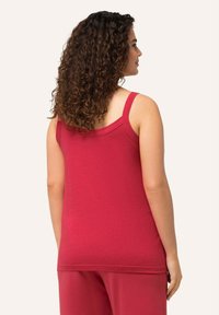 Red cotton tank top with wide straps, featuring a rounded neckline and a fitted silhouette, shown from a side and back view.