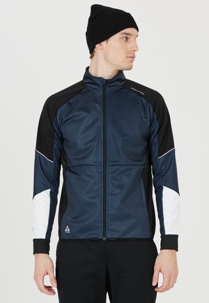 Marineblau und schwarze Sportjacke mit weißen Akzenten, Reißverschluss vorne, hohem Kragen und langen Ärmeln. Hergestellt aus glattem, leichtem Stoff.