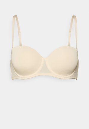 Beige gepolsterter BH aus glattem Stoff, mit UnterstÜtzung durch Bügel, verstellbaren Trägern und nahtlosen Schalen. Einfaches Design, geeignet für den täglichen Gebrauch.