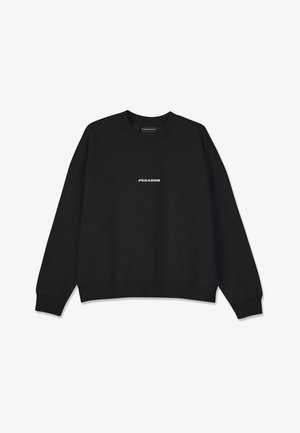 Black sweatshirt with a crew neckline and ribbed cuffs. Features white "PEGADOR" logo on the front. Made from soft fabric with a relaxed fit.