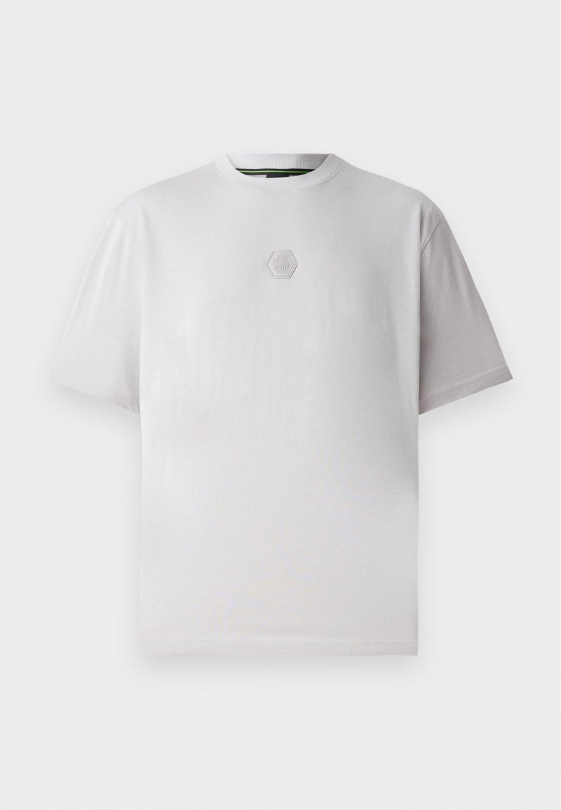 T-shirt bianco a maniche corte in cotone, con un logo esagonale in rilievo delicato sul petto, colletto a girocollo e vestibilità comoda.