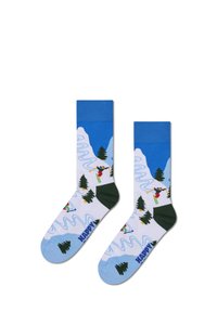 Calcetas hasta la rodilla con un paisaje montañoso nevado, en colores verde y azul, ilustraciones de esquí y el texto "HAPPY" en azul en la punta.