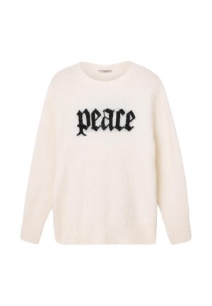 Biały włochaty sweter z okrągłym dekoltem i długimi rękawami. Na piersi widoczny napis „Peace” w czarnych, pogrubionych literach.