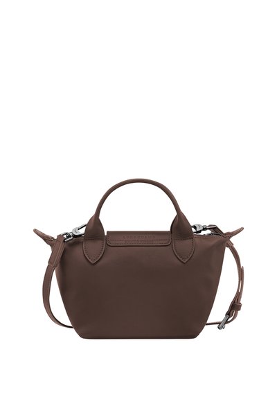 Small brown leather handbag with two top handles and an adjustable side strap, silver hardware, and a zipper closure.