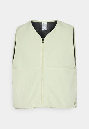Lys grøn ermeløs vest med glidelås, v-halsdesign, to frontlommer og svart innvendig fôr. Glatt tekstur, lett materiale.