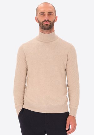 Maglione beige a collo alto realizzato in materiale morbido, con maniche lunghe e design aderente. Le costine sui polsini e sull'orlo accentuano la silhouette.