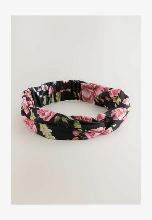 Floral headband made of fabric featuring large pink and smaller blue flowers on a black background, with a twisted design and elasticated back.