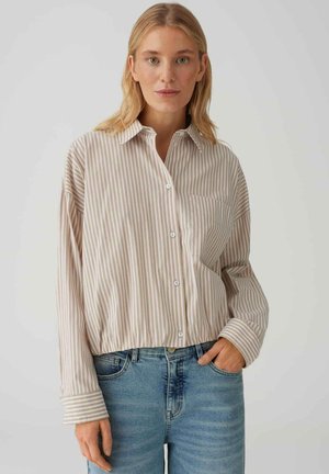 Hellbeiges gestreiftes Hemd mit durchgehender Knopfleiste, weiter Passform und einer Brusttasche. Lange Ärmel mit kontrastierenden gestreiften Manschetten.