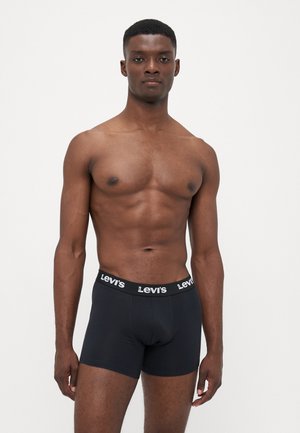 Schwarze Baumwollboxershorts mit breitem elastischem Bündchen, das mit weißem "Levi's"-Branding versehen ist, figurnahem Design und glatter Textur.