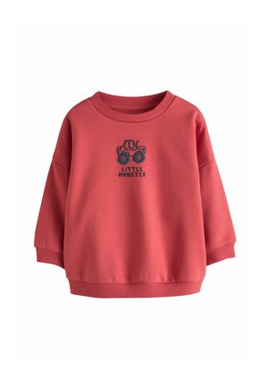 Red toddler sweatshirt with a black tractor graphic and the words "LITTLE MONSTER" printed below the graphic on the front.