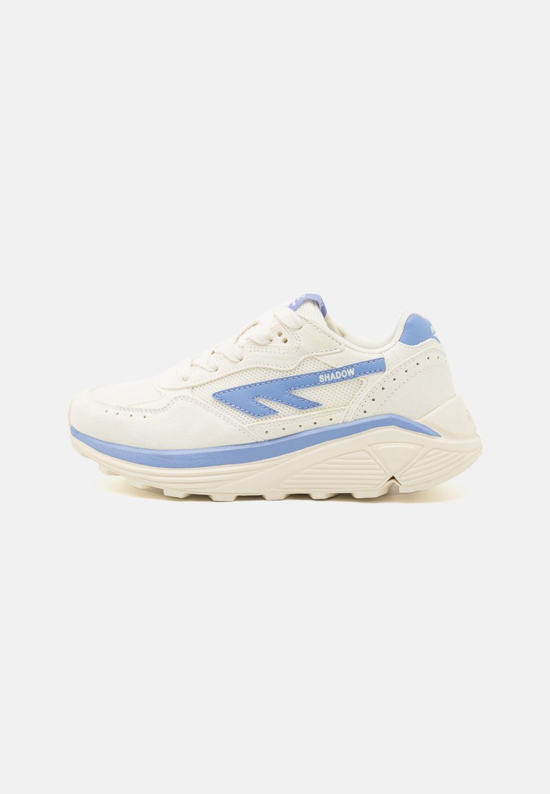 White and light blue sneaker featuring a mesh upper, textured accents, rounded toe, and cushioned sole. "SHADOW" logo on the side.