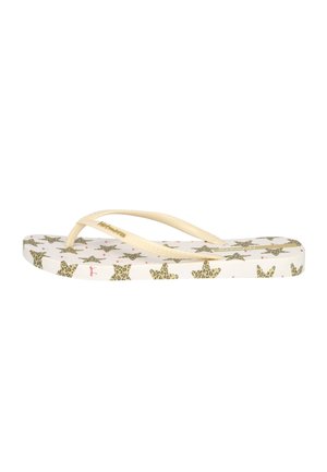 Sandalia flip-flop blanca con tiras beige y un patrón de estrella con estampado de leopardo en la suela y los lados.
