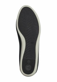 Black rubber shoe sole with textured surface and grooves, bordered by a white accent line; features a circular logo imprint.