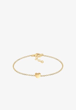 Zlatý náramok s malým srdiečkovým príveskom. Reťaz má jemný, okrúhly dizajn článkov. Obsahuje zapínanie a predlžovaciu reťaz na nastavenie dĺžky.