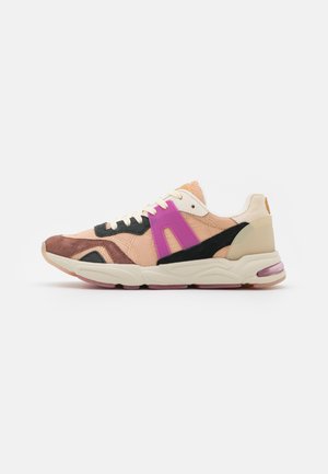 Sneakers featuring a mix of peach, black, and brown materials, with a bold purple accent, textured panels, and a cushioned sole.
