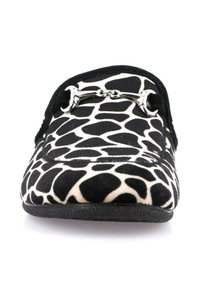Mocassino bianco e nero con stampa giraffa, parte superiore in tessuto morbido, dettaglio in metallo sulla parte anteriore e punta arrotondata con suola piatta.