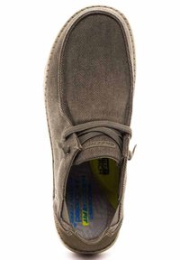 Zapato de lona marrón con punta redondeada, diseño con cordones, parte superior texturizada y color de plantilla en contraste. Suela de goma y cuello acolchado.