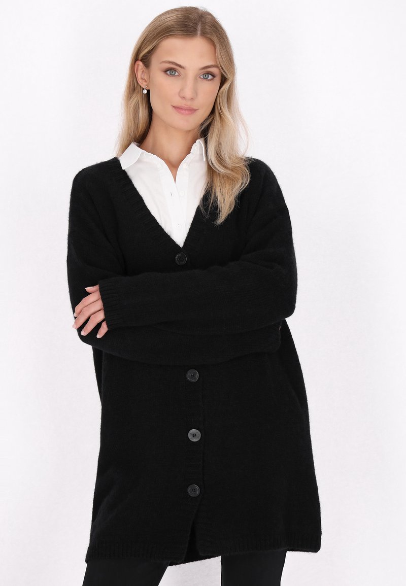Schwarze strickjacke mit V-Ausschnitt, langen Ärmeln und fünf schwarzen Knöpfen auf der Vorderseite. Weicher Stoff und lockere Passform.