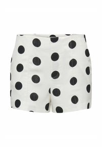 Pantalones cortos blancos de cintura alta con grandes lunares negros, detalles en la costura delantera y cierre de cremallera oculto.