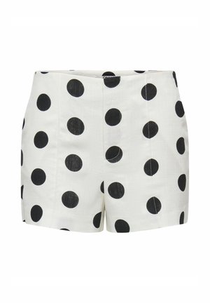 Short blanc taille haute avec grands pois noirs, détails de couture devant et fermeture éclair invisible.