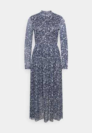 Robe maxi bleu marine à manches longues avec imprimé floral blanc, col montant, taille froncée et détails en tissu transparent sur les manches et la jupe.