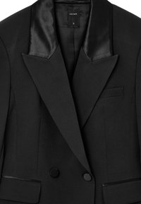 Black blazer with satin peak lapels, double buttons, single chest pocket, and sleek fabric texture. Tag displays brand "CALLIOPE" and size "S."