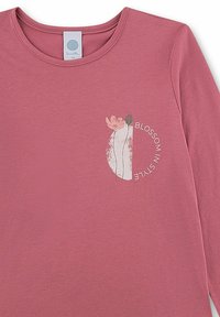 Dusty pink long-sleeve shirt with round neck, floral graphic, and "Blossom in Style" text curved around the design on the chest.