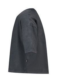 Black short-sleeve T-shirt with a loose fit, round neckline, and a small side label. Fabric appears soft with a slightly worn texture.